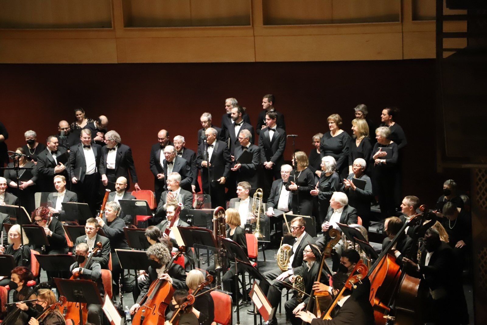 Choir and orchestra perform on stage.