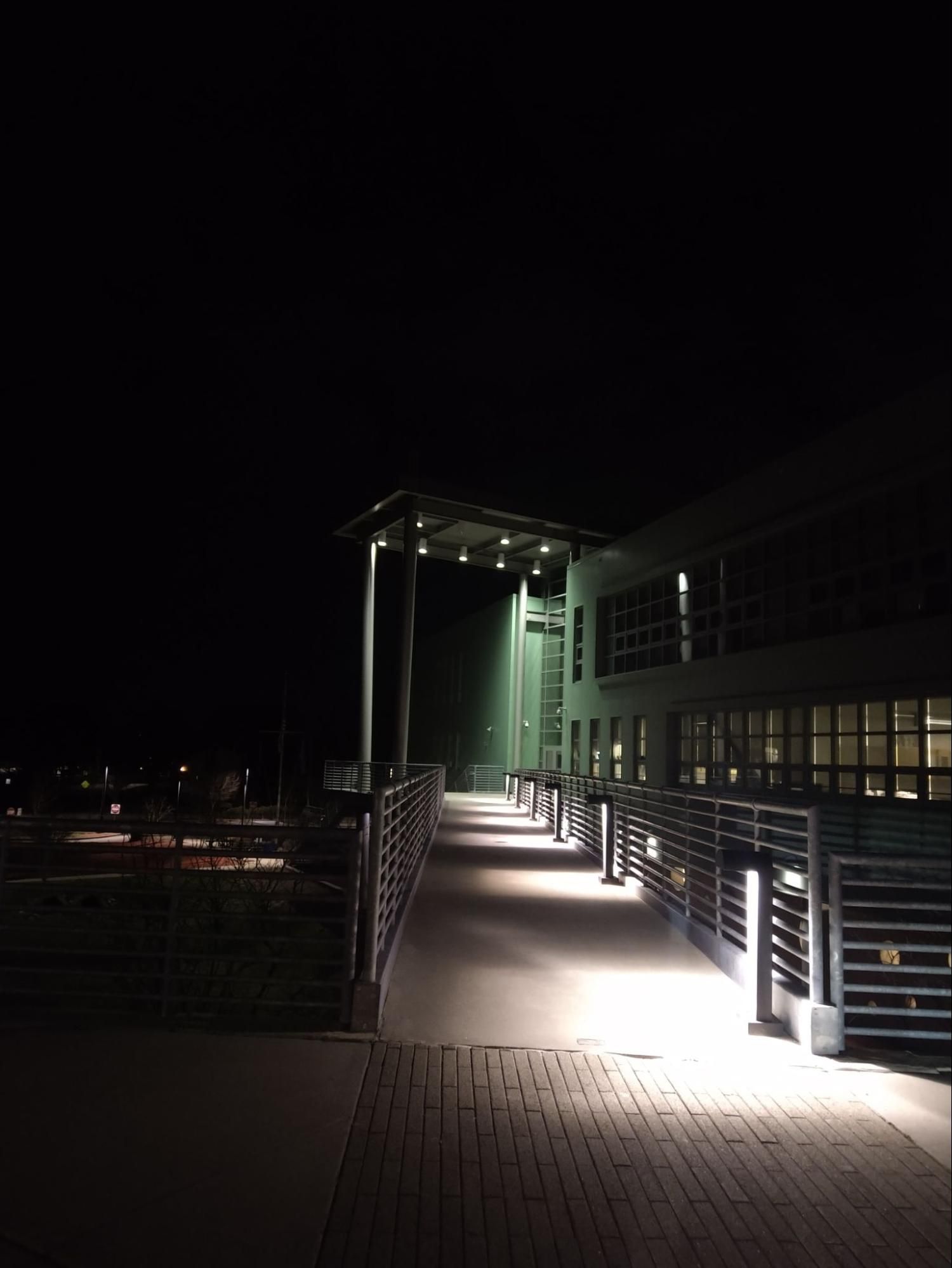 The bridge of MSMHS at night, lit by lights.